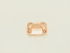 Small rectangular peach-pink sapphire gem, on white background.
