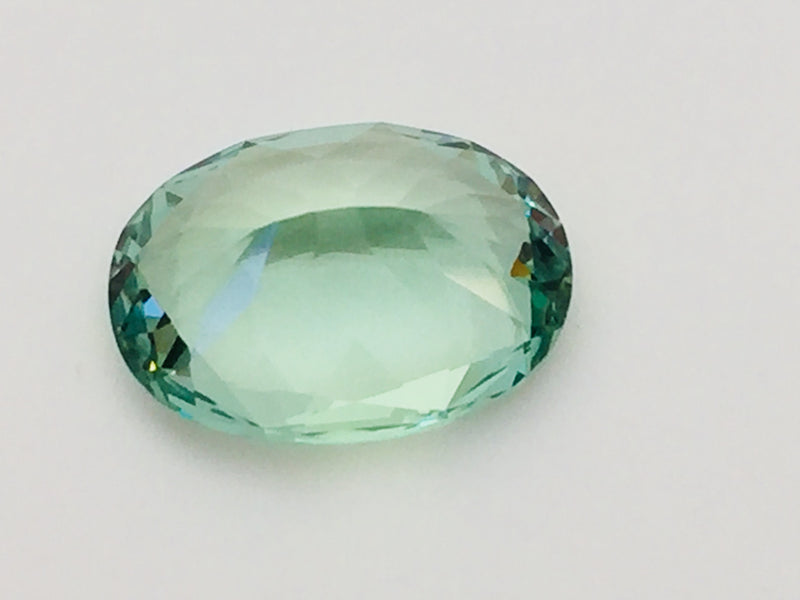 Large oval green beryl gem, on white background.