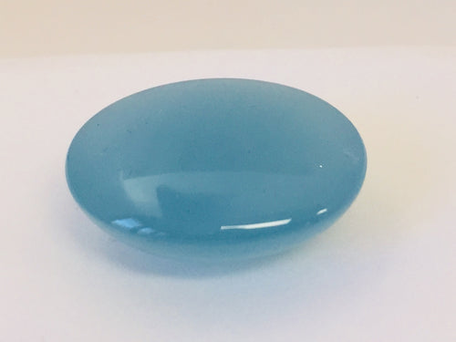Large oval light blue cabochon aquamarine gem, white background.