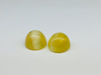 A pair of yellow opal with cat's eye phenomenon.
