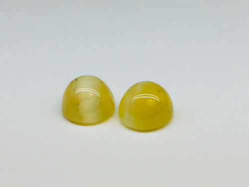 A pair of yellow opal with cat's eye phenomenon.