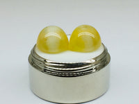 A pair of yellow opal with cat's eye phenomenon.
