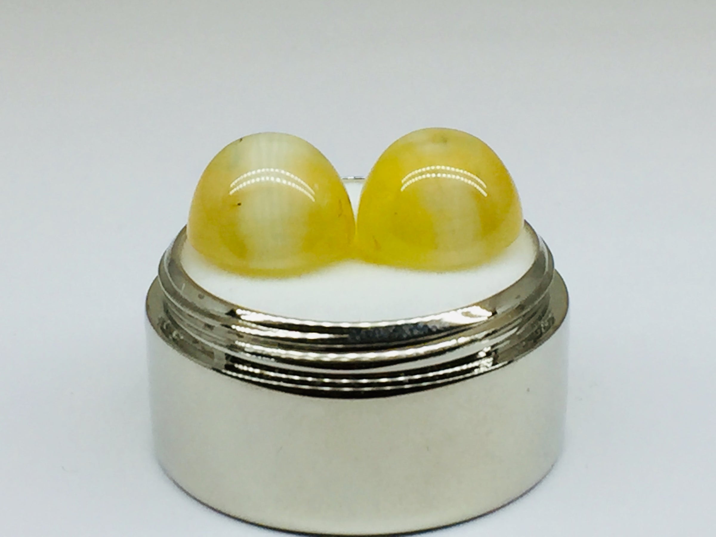 A pair of yellow opal with cat's eye phenomenon.