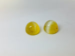 A pair of yellow opal with cat's eye phenomenon.