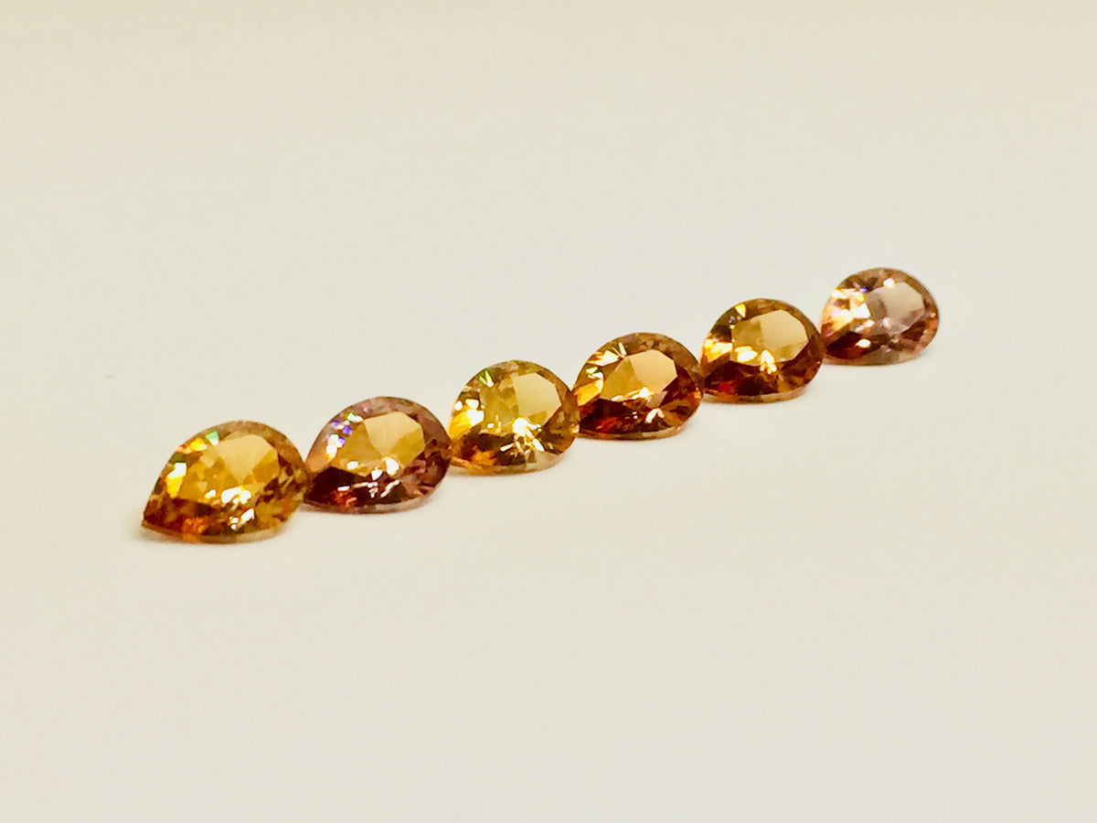 Set of six cognac coloured natural zircon, pear shaped.