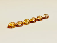 Set of six cognac coloured natural zircon, pear shaped.