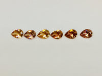 Set of six cognac coloured natural zircon, pear shaped.
