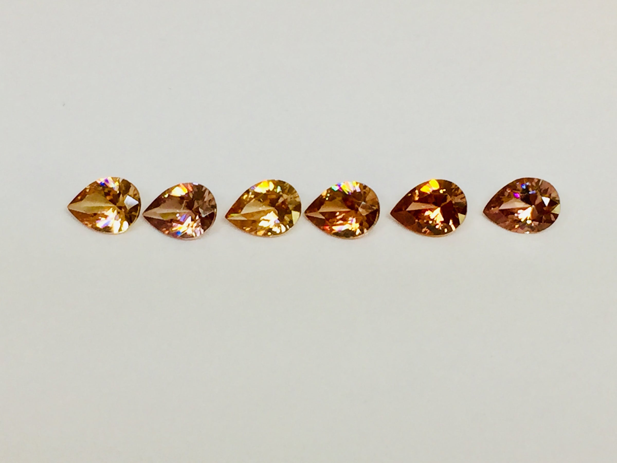 Set of six cognac coloured natural zircon, pear shaped.