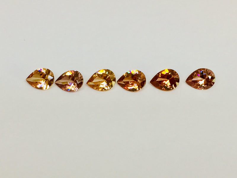 Set of six cognac coloured natural zircon, pear shaped.