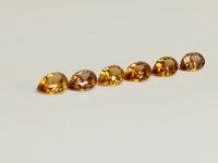 Set of six cognac coloured natural zircon, pear shaped.