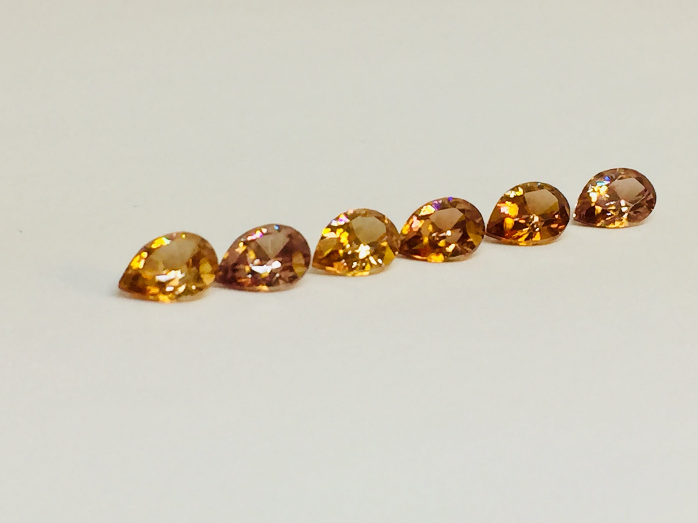 Set of six cognac coloured natural zircon, pear shaped.