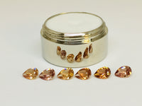Set of six cognac coloured natural zircon, pear shaped.