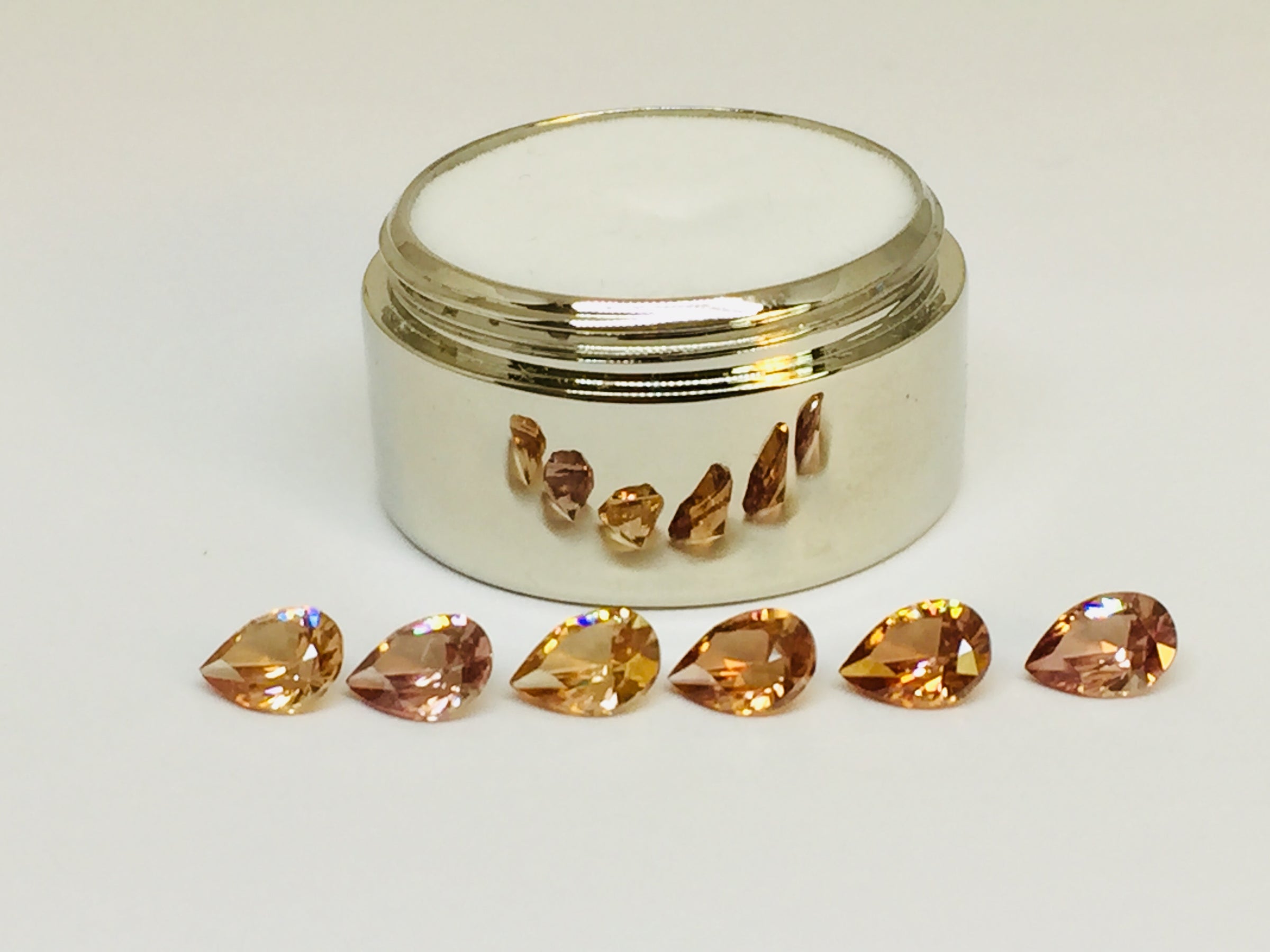 Set of six cognac coloured natural zircon, pear shaped.