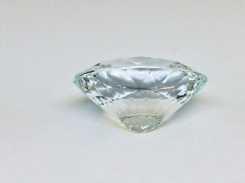 Very large, colourless topaz, white background.