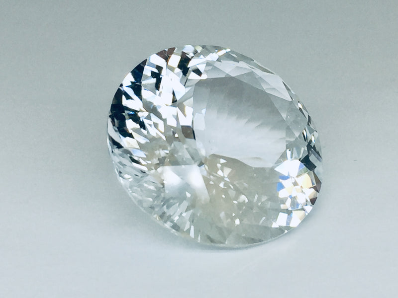 Very large, colourless topaz, white background.