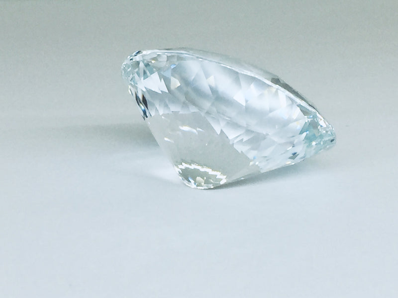 Very large, colourless topaz, white background.