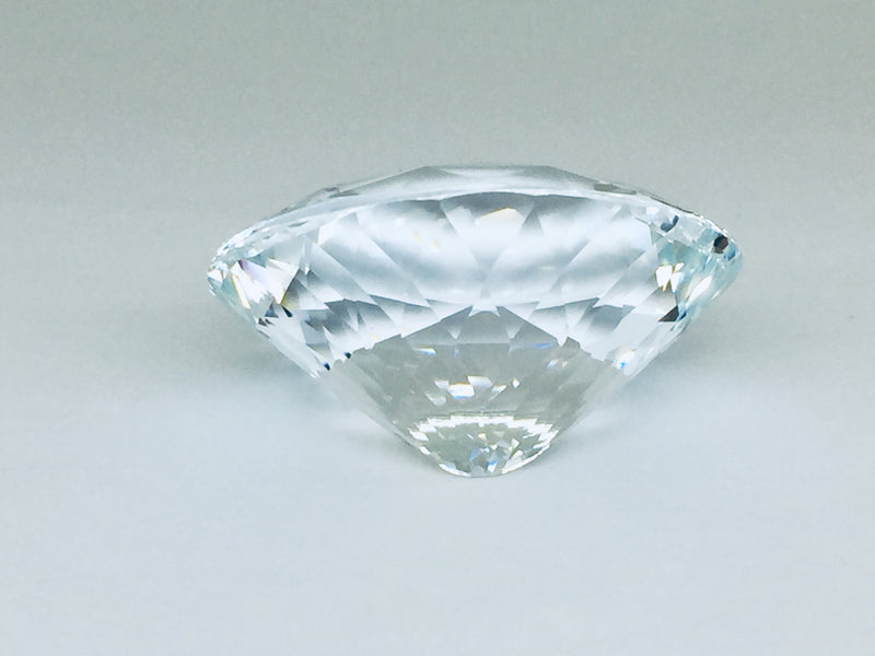 Very large, colourless topaz, white background.