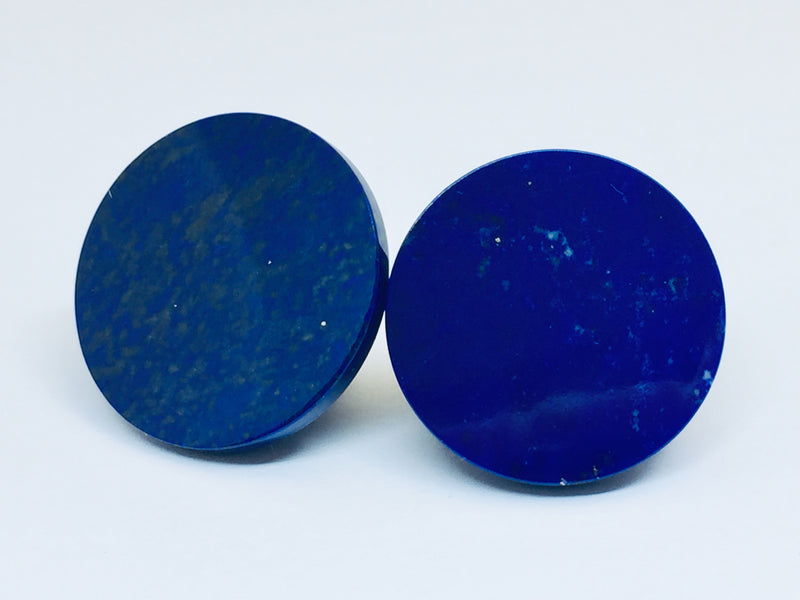 Lapis lazuli pair of cone-shaped gems, white background.