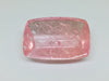 Very large cabochon of morganite (pink beryl) gem, white background.