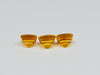 Three buff top citrine gems, white background.