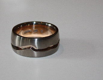 Man's wide white gold band with groove.