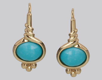 Yellow gold earrings on shepherd hooks set with oval blue turquoise. 