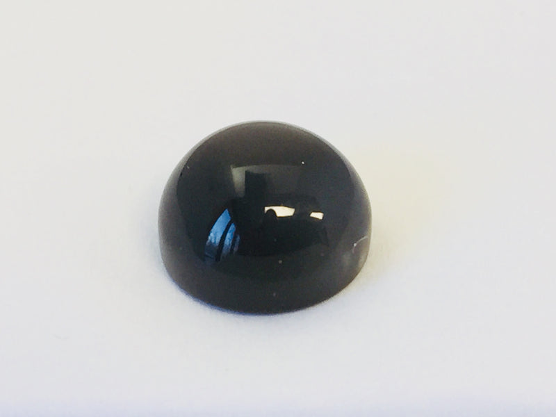 Large round charcoal grey moonstone gem, white background.