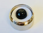 Large round charcoal grey moonstone gem, white background in gem jar.