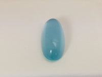 Long light blue aquamarine gem, white background.