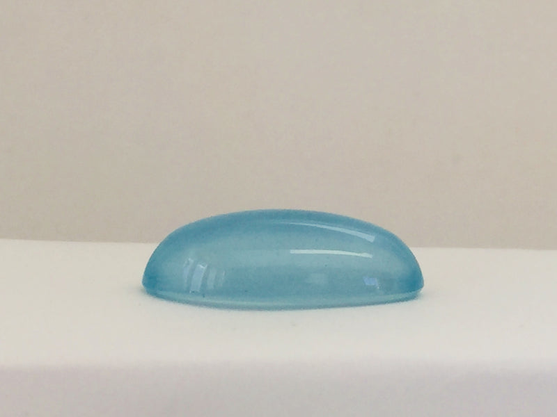 Long light blue aquamarine gem, white background.