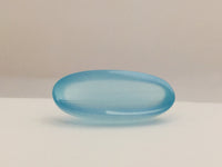 Long light blue aquamarine gem, white background.