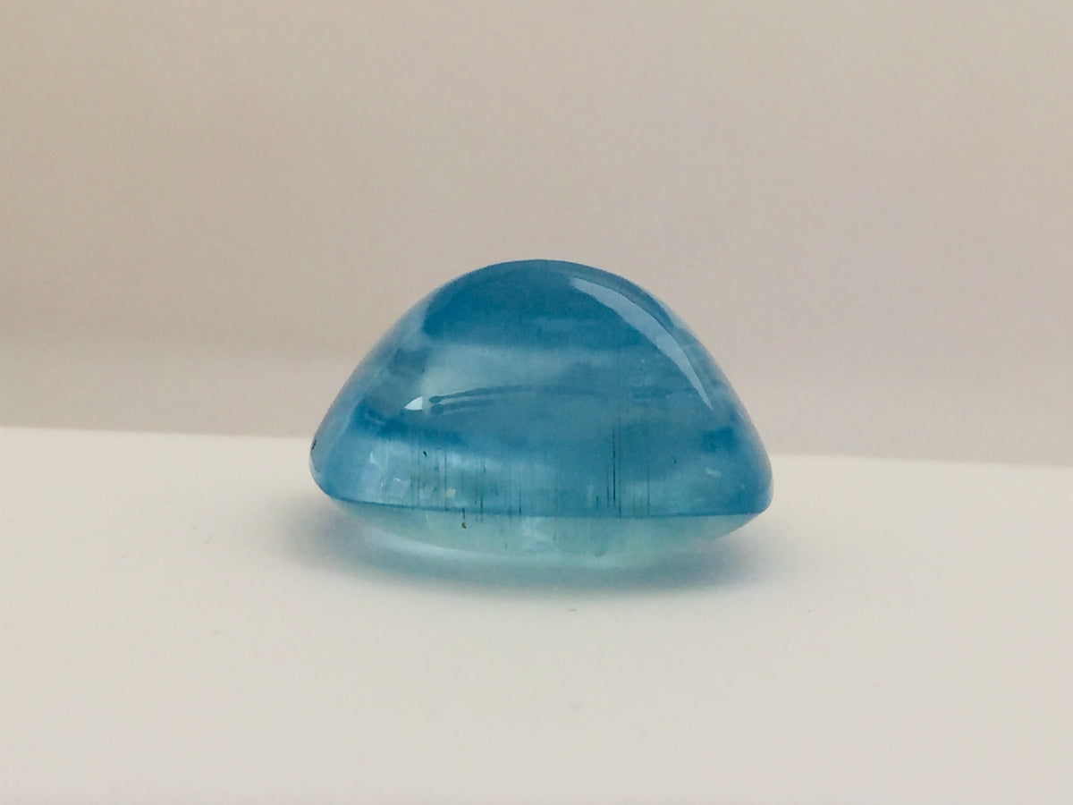 Large rectangle rich light blue aquamarine gem, white background.