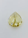 Large pear shaped light yellow chrysoberyl gem, on white background.