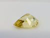 Large pear shaped light yellow chrysoberyl gem, on white background.