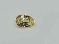 Large pear-shaped green-yellow chrysoberyl gem, white background.