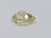 Medium pear-shaped yellow sapphire gem, white background.