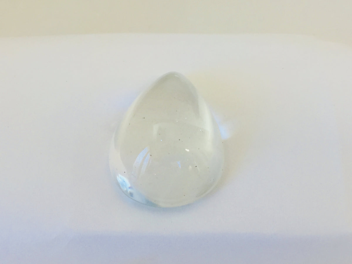 Very large colourless tear-drop shape white topaz gem, white background.
