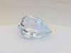 Very large colourless tear-drop shape white topaz gem, white backgroound.