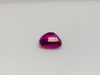 Small rectangle fuschia pink sapphire gem, white background.
