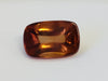 Rectangular deep golden brown cabochon zircon gem, on white background.
