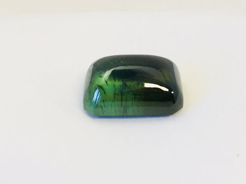 Large rectangle green zircon cabochon gem, white background.