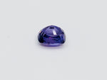 Deep purple coloured sapphire gem, white background.