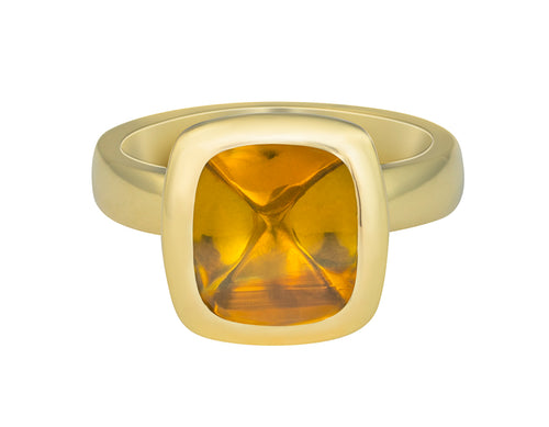Green gold ring set with upside down medium square cabochon of golden zircon. Gem is set in a frame.