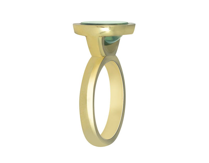 Green gold ring set with upside down large oval cabochon of green zircon. Gem is set in a frame.