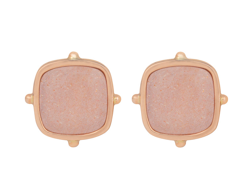 Square light orange gems in rose gold frame.