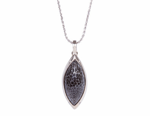 White gold pendant set with mottled black and grey gem and four accent diamonds, on white gold chain.