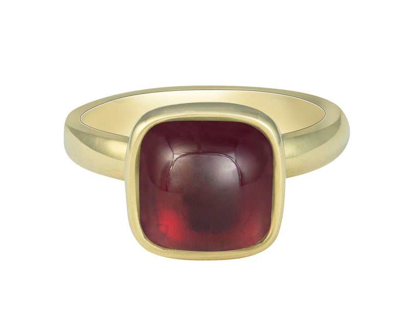 Medium size square cabochon of raspberry red rhodolite frame set in green gold ring.