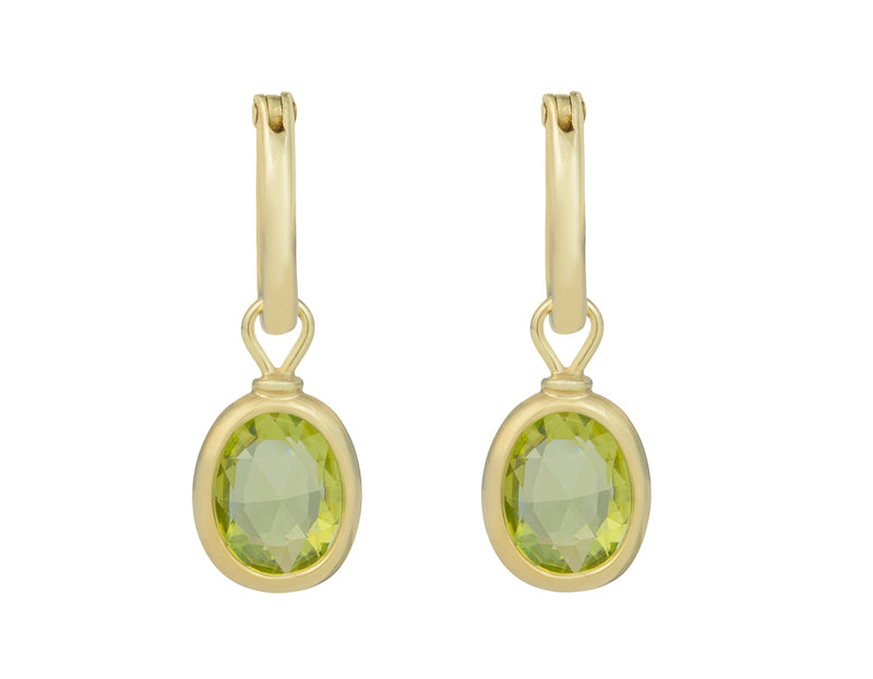 Oval drops in green gold set with apple green gems. Drops hang on small U shaped hoops in solid green gold.