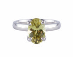Platinum ring set with an oval chrysoberyl. The gem shows flashes of yellows, greens, browns etc. The gem is prong set and sits above the band.