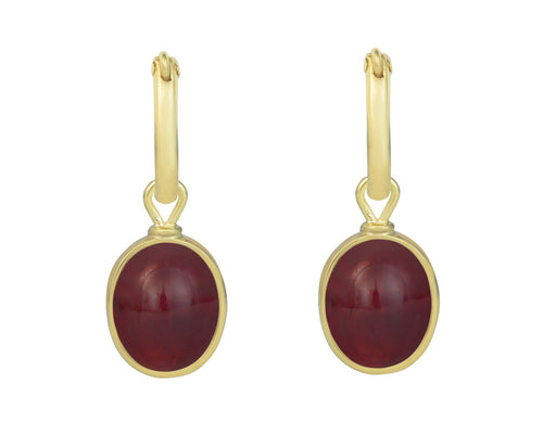 Small oval drops in green gold set with raspberry red gems. Drops hang on small U shaped hoops in solid green gold.